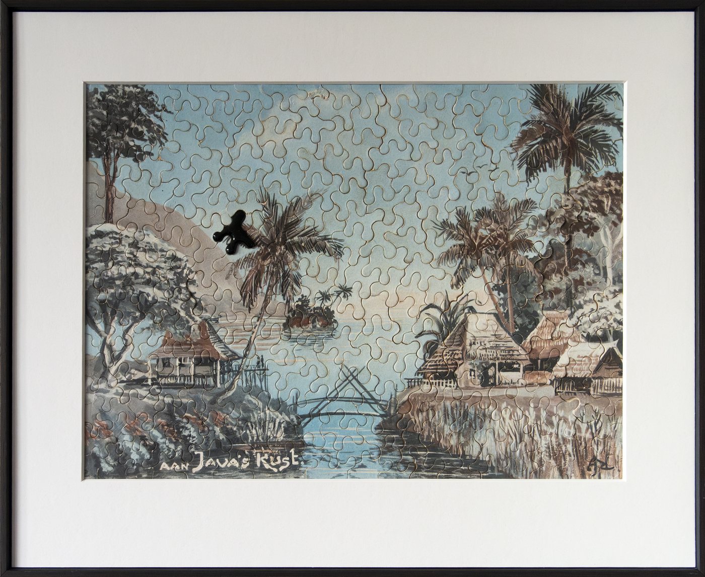 The Missing Link, 2025 - a framed jigsaw of a tropical river scene with palms and huts, one dark bird-shaped piece resting where the puzzle is unfinished.